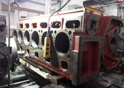MAN 6L23/30h diesel engine block machining on the boring machine inside a mechanical workshop.